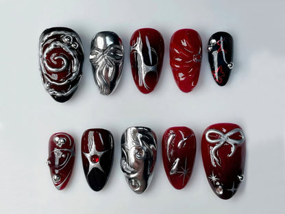 Unique 3D Nail Art Designs: Handcrafted Red and Silver Swirl and Symbolic Accents