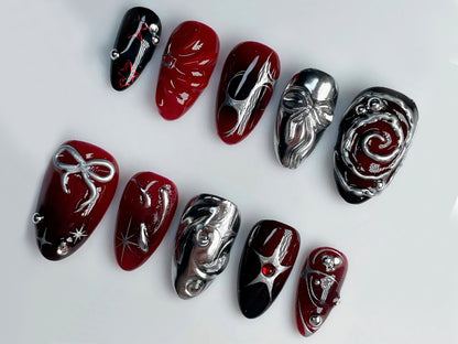 Unique 3D Nail Art Designs: Handcrafted Red and Silver Swirl and Symbolic Accents